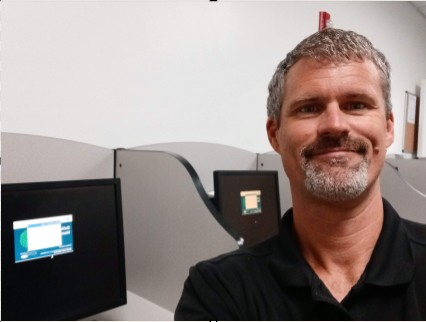 A photo of Chris in the I.T. lab